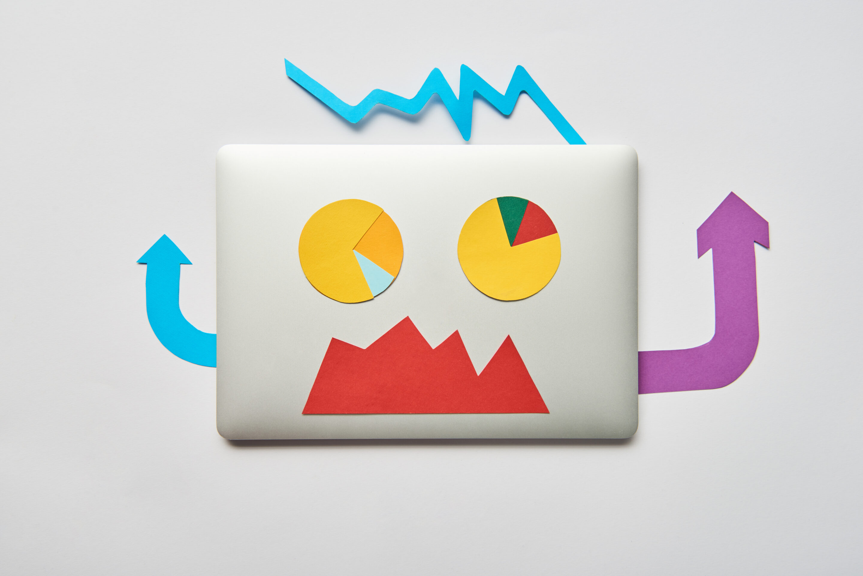 Angry CEO in tension trying to manage an organizational crisis in a boardroom Back of a white lapop, with stick-on paper graphs, charts and arrows to form a face, arms, and hair