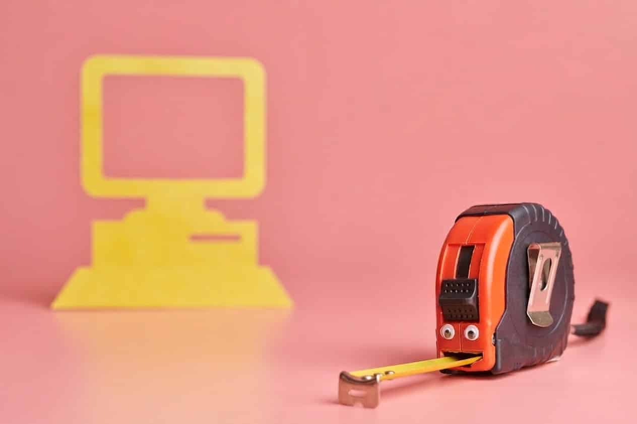 Tape measure and paper. Hidden cost of IT