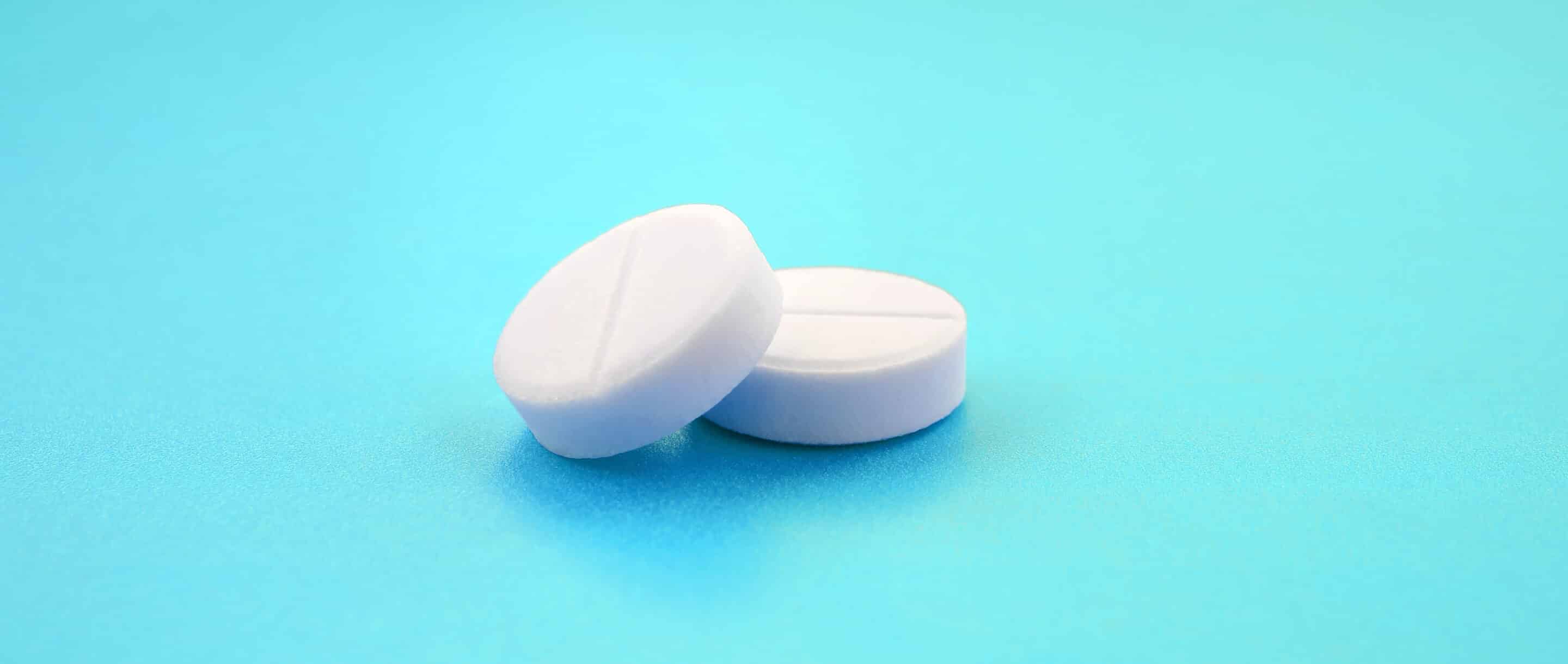 2 white tablets on blue background