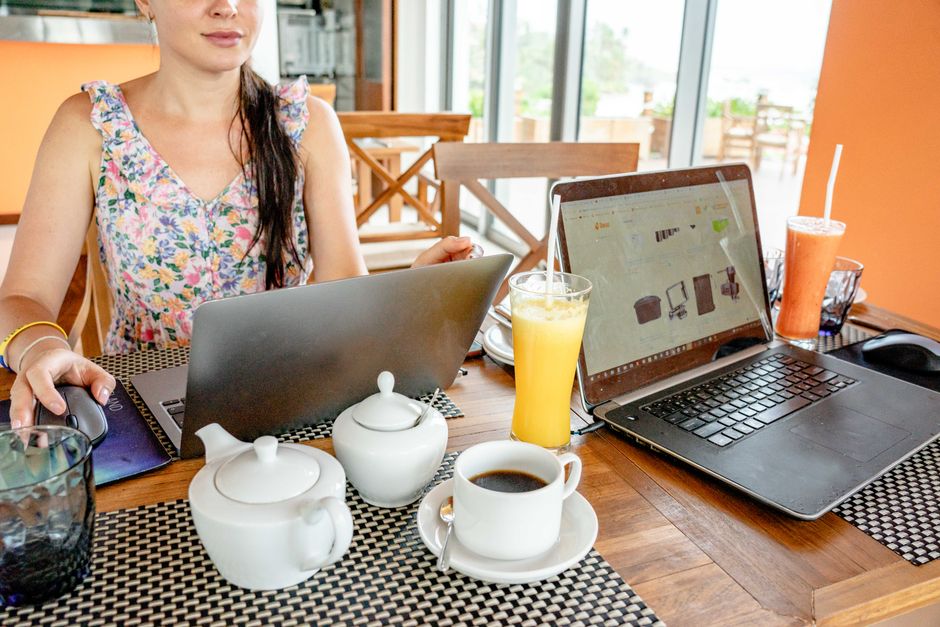 A solicitor working from home on a laptop, reviewing documents at a tidy desk with a second monitor